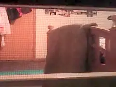 College chick Filmed Through Window